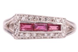An Art Deco style ruby and diamond three-row ring; composed of three calibré cut rubies within a bor