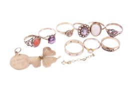 A collection of 9 gold rings a medallion charm, a small length of chain and a partial pearl set flow