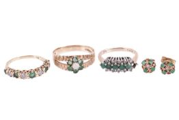 A collection of three rings and a pair of earrings; the emerald and diamond half hoop ring alternate