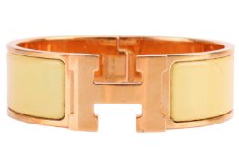 Hermès - A wide 'Clic H' bracelet with lemon yellow enamel and gold-tone metal, signed and marked, i