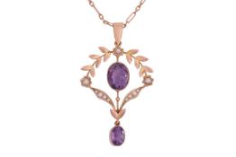 An amethyst and seed pearl pendant featuring a central oval amethyst measuring 9.5 x 7.5mm, in a flo