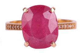 An oval cut ruby ring; the oval mixed cut ruby in simple four claw mount to a yellow metal shank sta
