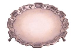 An Edwardian silver salver, by Edward Barnard & Sons Ltd, London 1908, of circular form with pie