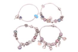 Four Pandora bracelets; each bracelet with assorted rondels and charms, with clasps marked with Pand