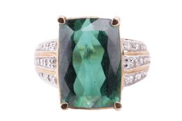 A single stone green tourmaline dress ring; the rectangular cushion cut stone in a four claw mount w