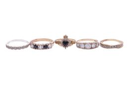Five rings comprising a synthetic sapphire and cz set Claddagh ring in 9ct yellow gold, size L; a ha