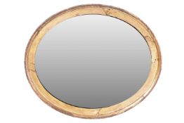 A Victorian oval gilt wood wall mirror with moulded surround, fitted with an aged replacement mirror