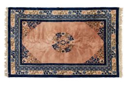 A salmon ground Chinese 'Pekking' carpet with central floral boss within blue and oatmeal borders, 2