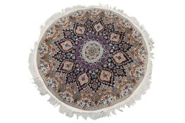An ivory ground circular Nain rug with a central boss within a floral border, 130 cm diameter