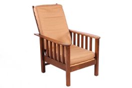 An Arts and Crafts style oak reclining armchair in the manner of Gustav Stickley, 60 cm wide x 100 c