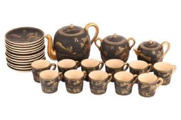 A Japanese matte black Satumsa tea set with gold hand-painted decoration, comprising of a teapot, li