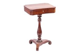 A French 19th-century figured rosewood pedestal work table with a fitted interior, over a concave sc