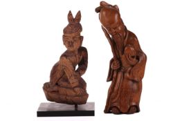 A Chinese-carved bamboo figure of Shou Lao, late Qing Dynasty with peach staff and bat peering from 