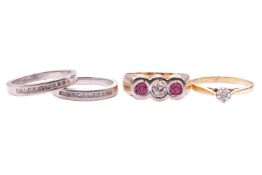 A synthetic ruby and diamond 3-stone ring, the central transitional-cut diamond measuring approximat