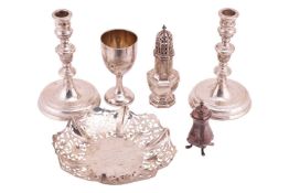 A pair of silver candlesticks with weighted bases, 19cm high, together with a pierced silver bowl wi