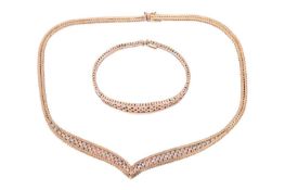 A 9ct tri-colour gold necklace and matching bracelet, the chevron-shaped collar necklace measuring a