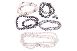 A pair of diamond-set peacock pearl drop earrings and five pearl necklaces including a three-strand 