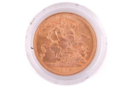 A 1958 Elizabeth II Full-Sovereign with a plastic case, circulated.