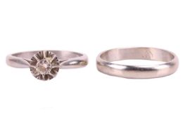 A diamond-set solitaire ring and matching wedding band; the illusion-set round brilliant diamond mea