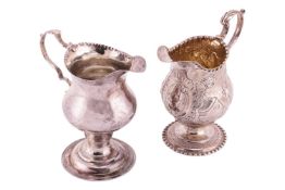 A George II silver ogee pedestal cream jug, London 1740 maker T.S (not found) with double scroll han