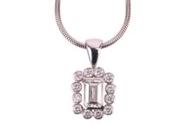 A diamond-set cluster pendant, the centrally-set emerald-cut diamond measuring approximately 6mm x 4