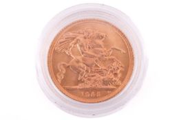 A 1965 Elizabeth II Full-Sovereign with a plastic case, circulated.