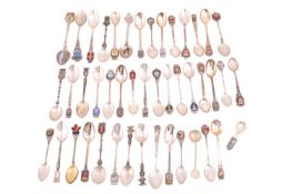 A collection of forty one silver and white metal souvenir spoons, many enamelled; together with four