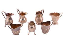 A collection of silver cream jugs of varying design to include Birmingham 1964 and other small silve