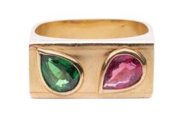 A gem-set ring, featuring a pear-shaped rubellite and tsavorite, each bezel-set obliquely in an angl