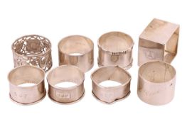 Eight assorted napkin rings, including examples of a cubic silver ring by Martin, Hall & Co, a C