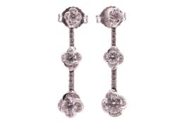 A pair of diamond-set drop earrings, with each earring featuring three diamond-set links of floral d