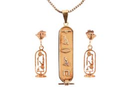 An Egyptian pendant and pair of earrings; the pendant featuring hieroglyphs to a vertical bar, with 