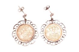 A pair of mounted gold half-sovereign earrings, each set in 9ct gold mounts with scrolling design, t