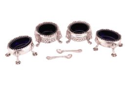 A pair of George III silver salts, oval with gadrooned borders and four shell mounted spreading shel