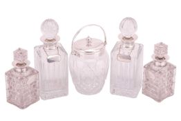 A pair of silver collared square section cut crystal spirit decanters with slice cut stoppers bearin