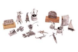 A collection of miniatures comprising a white metal figure of a soldier and guard hut, a silver cann