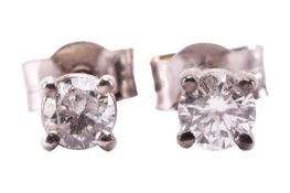 A pair of diamond stud earrings, featuring round brilliant diamonds measuring approximately 3.5mm ea