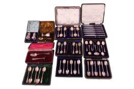 A collection of ten cased sets of silver, including an egg cup and spoon, a child's spoon and pusher
