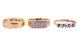 A collection of three rings, including a diamond five stone ring with a total estimated diamond weig