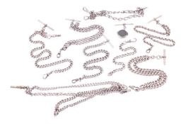 A collection of silver jewellery items with chains, including seven Albert chains with T-bars, a hea