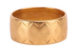 A 22ct gold wedding band, set with a star pattern throughout and with full hallmarks for 22ct gold t