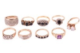 A collection of nine gem-set gold rings comprising an 18ct gold sapphire and diamond cluster ring, a