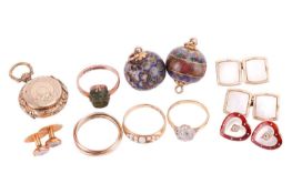 A mixed collection of shirt studs and other items. The dress studs include a pair of red guilloche e