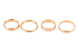 Four gold wedding bands, comprising three 22ct yellow gold bands, sizes I1/2, N & P, together wi