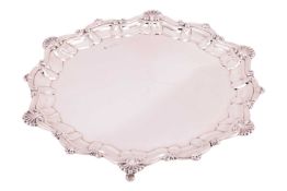 A silver salver by Atkin Brothers, Sheffield 1921, of circular form with shell and scrolled Bath rim