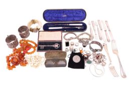 A quantity of white metal jewellery, two amber bead necklaces, a coral necklace, a pair of lorgnette