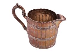A Victorian silver milk jug of coopered pale form, London 1874 by the Goldsmiths Alliance. 10.5 ozt,