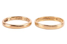 Two wedding bands in 18ct gold; the first with traces of engraving around the band, with English hal
