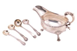 A George III silver sauce boat, with gadrooned border, leaf-capped flying double scroll handle, and 