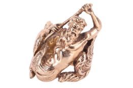 A yellow metal dress ring, depicting Poseidon with his trident emerging from the sea. The textured w